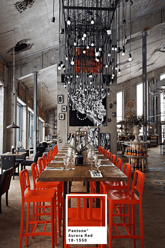 industrial-style-restaurant-interior-with-bright-red-chairs-pantone-aurora-red-min-with-square