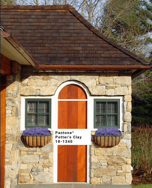 stone-cottage-with-burnt-orange-stained-wood-door-pantone-potters-clay-min-with-square