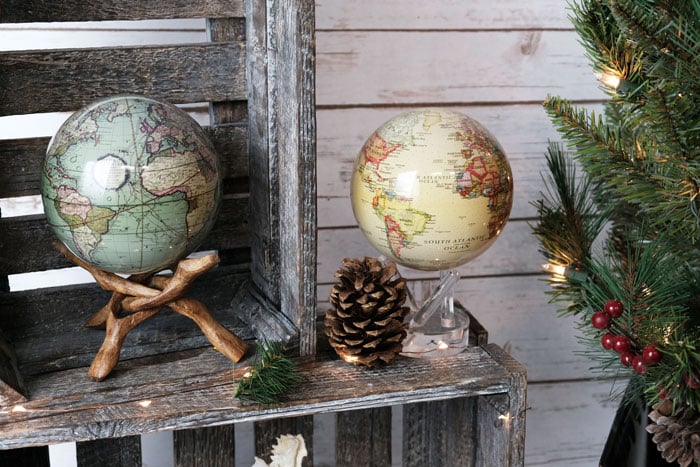 Green antique terrestrial globe and yellow political MOVA globe with christmas decor
